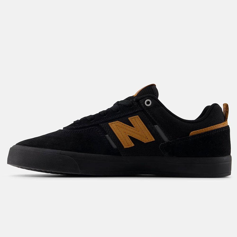 A white and black New Balance Numeric 306 BON suede skateboarding shoe, inspired by the Jamie Foy pro model, shown in side profile against a white background—a stylish vulcanized sneaker with signature detailing.