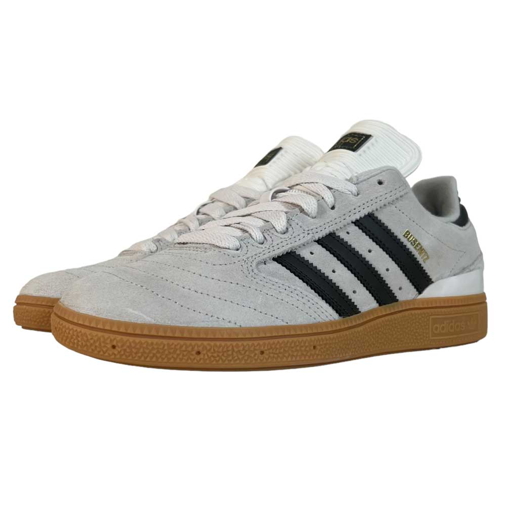The White Grey Shaoli Gum Busenitz Adidas Skateboarding Suede Shoes feature black stripes, a gum sole, white laces, a white tongue, and "BUSENITZ" in gold on the side.