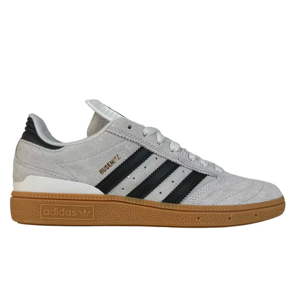 A side view of the White Grey Shaoli Gum Busenitz Adidas Skateboarding Suede Shoes, featuring black stripes, a gum sole, and BUSENITZ in gold lettering above the stripes—classic suede style.