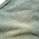 Close-up of Tinted Blue Wash Denim fabric, showcasing its texture and diagonal weave in the Wide Cut Tinted Blue Wash Denim Jeans by Butter Goods. Subtle wear and gentle fading enhance the authentic look.