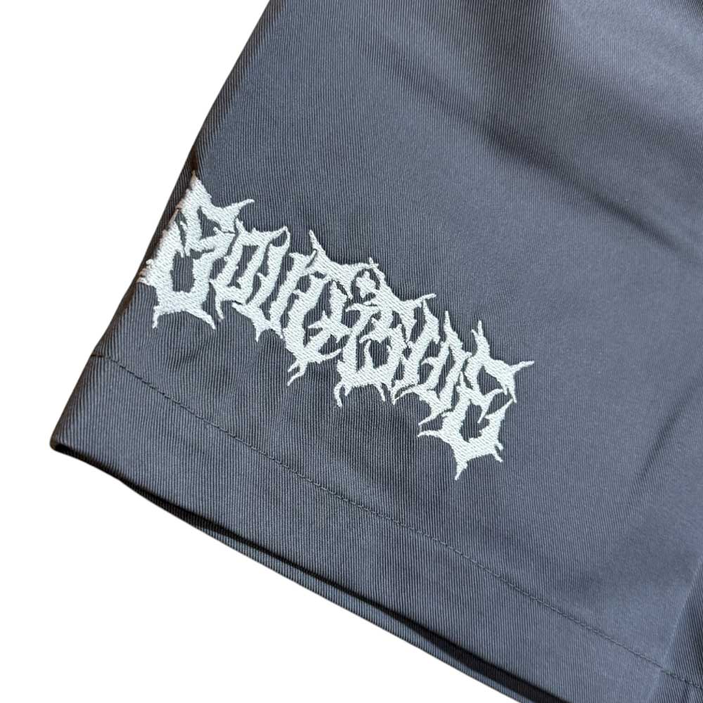 A close-up of dark gray YOUTH Texas Icon Gray Southside 94 Shorts, featuring "Religious" embroidered in white, jagged, gothic-style letters on the lower left corner.
