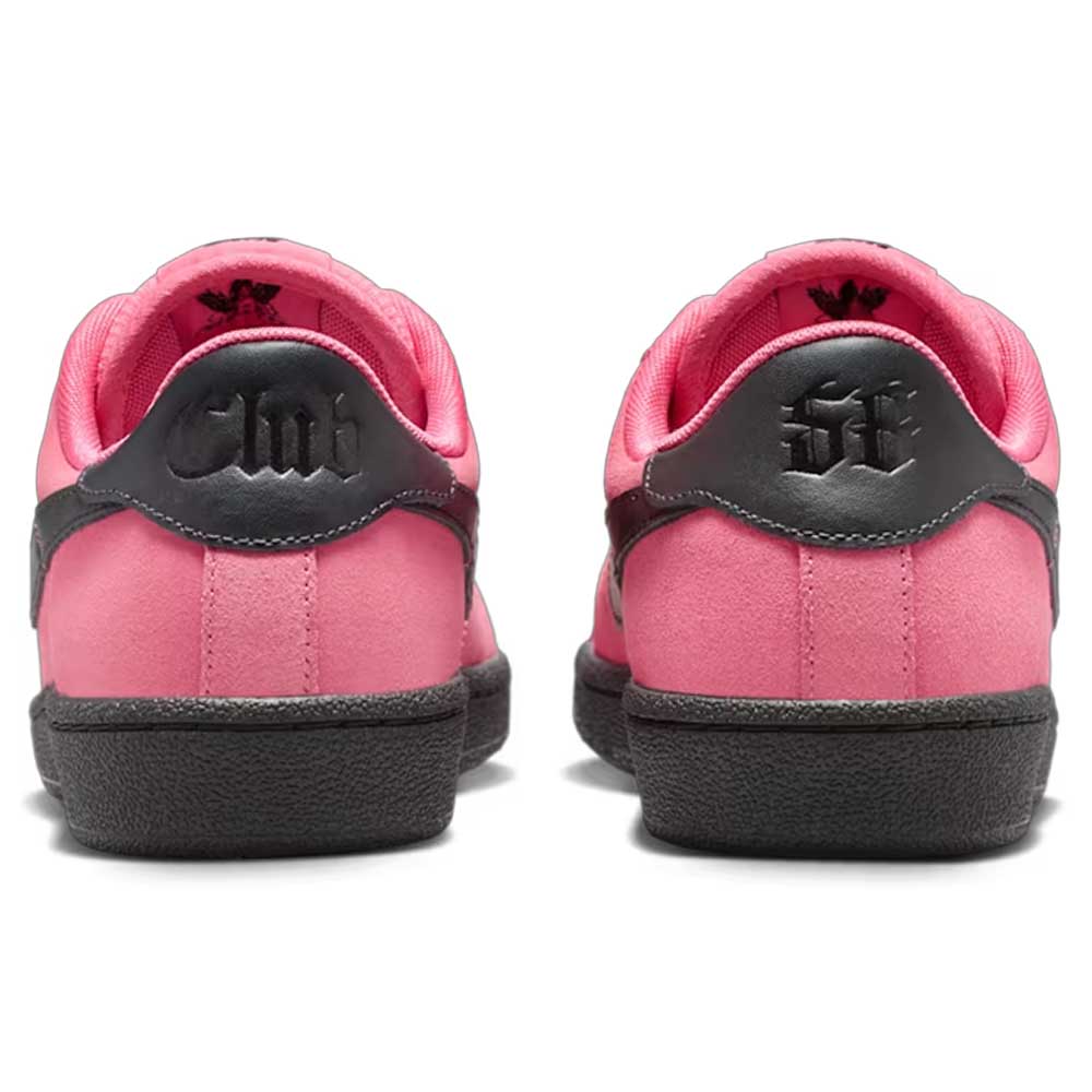 The Nike SB Zoom Tennis Classic IO8394600 Hyper Pink Black skate shoes feature black soles and heels, gothic-style black lettering on the back, pink interiors, and a rear view highlights their striking design.