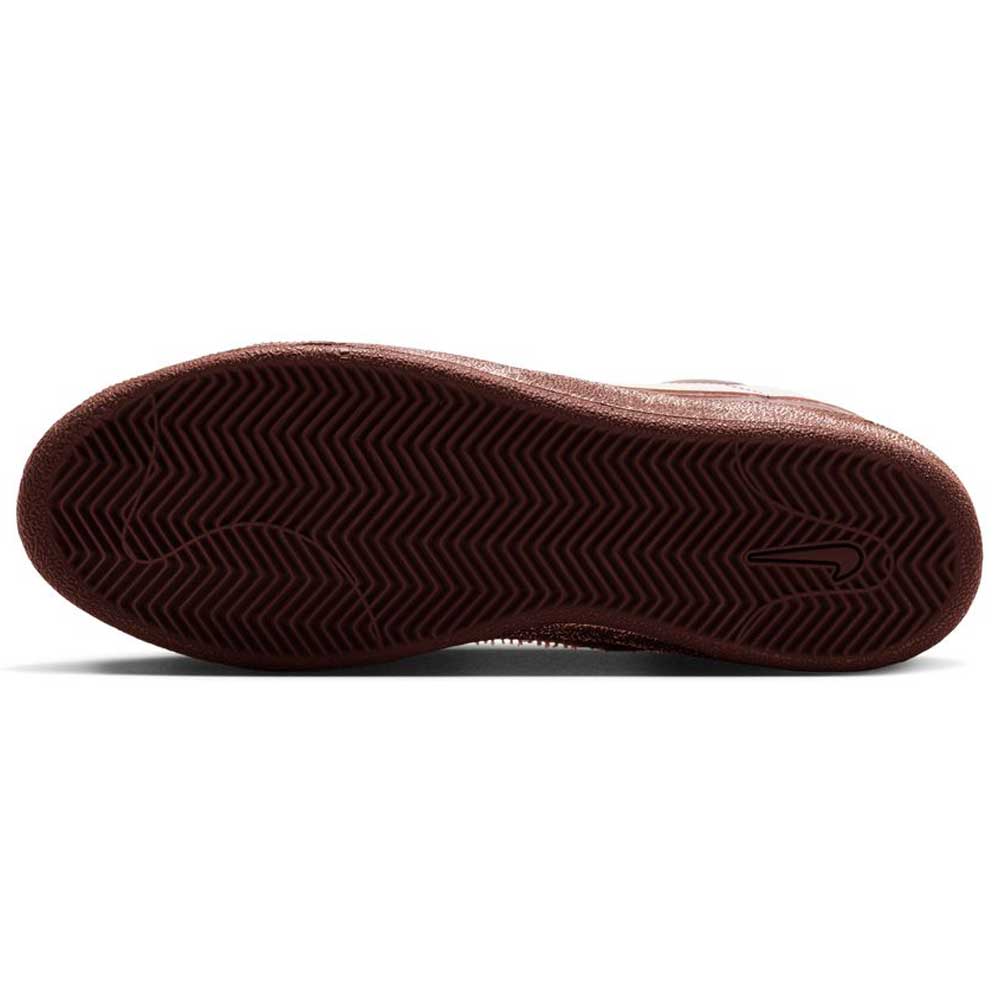 The image shows the brown, textured rubber sole of a Zoom Tennis Classic x Rassvet IO9846400 Blue Void Sail Nike SB Leather Skateboarding Shoe, featuring a herringbone tread pattern and a small Nike swoosh logo near the heel.