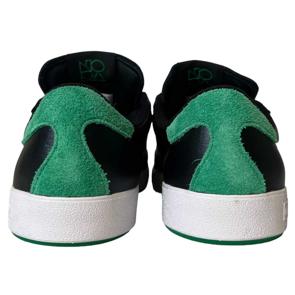 Back view of Adidas Nora Black Green White Leather Shoes with black uppers, white soles, and green suede heel accents, featuring NOXA text on the inner heel lining.