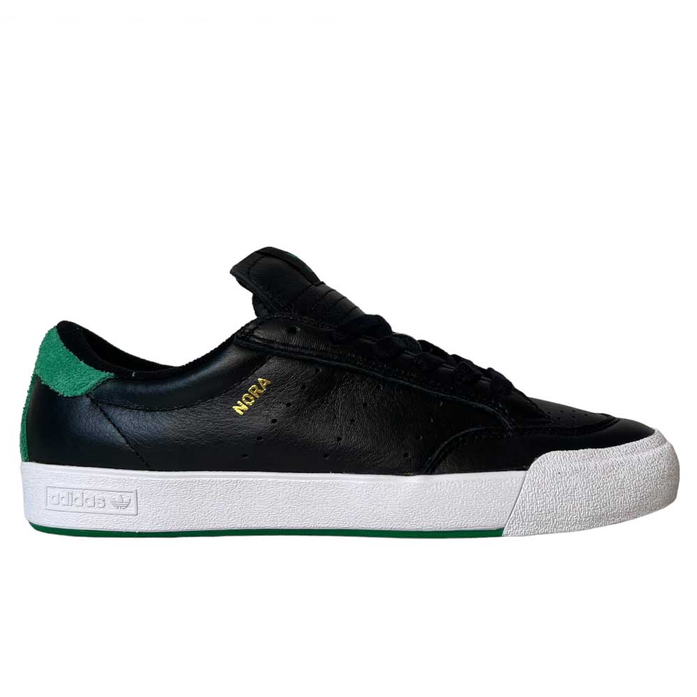 The Adidas Nora Black Green White Leather Shoes are low-top skate sneakers featuring a black upper, white sole, green heel tab and outsole accents, plus "NORA" in gold on the side for a vintage-inspired look.