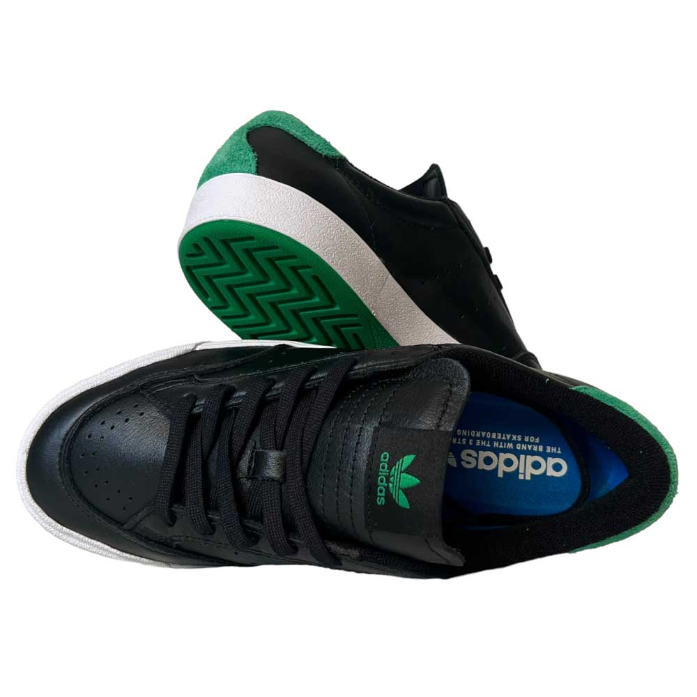 The Adidas Nora Black Green White Leather Shoes feature black leather uppers with green accents, a green heel tab, white soles, visible green-treaded sole, and blue Adidas Skateboarding Nora insole branding.