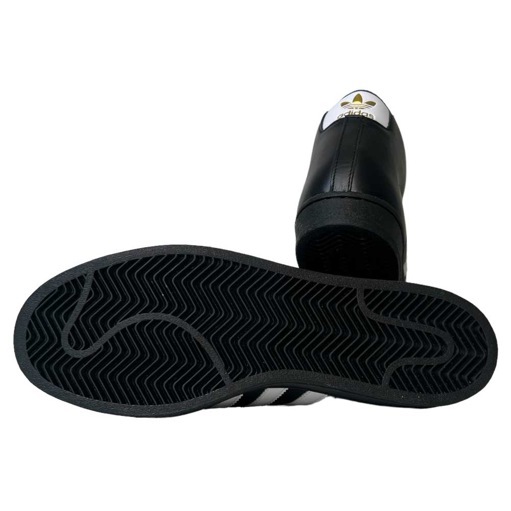 A pair of Adidas Pro Model ADV Black White Gold Leather Shoes is displayed: one upright to feature the tongue and logo, the other on its side to showcase the textured leather sole pattern.