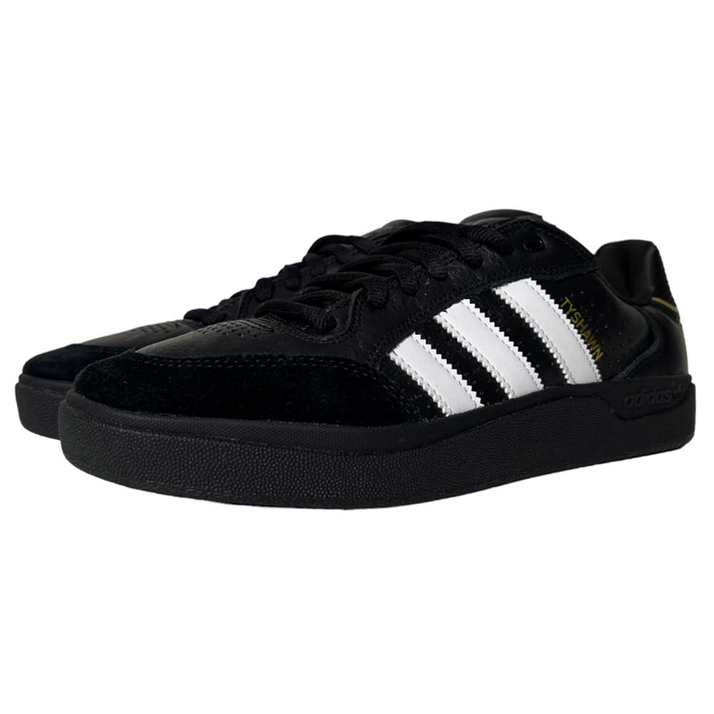 A pair of Tyshawn Low Adidas Skateboarding Black White Leather Suede Shoes with black laces and a black sole, featuring white stripes, viewed from a slight angle.