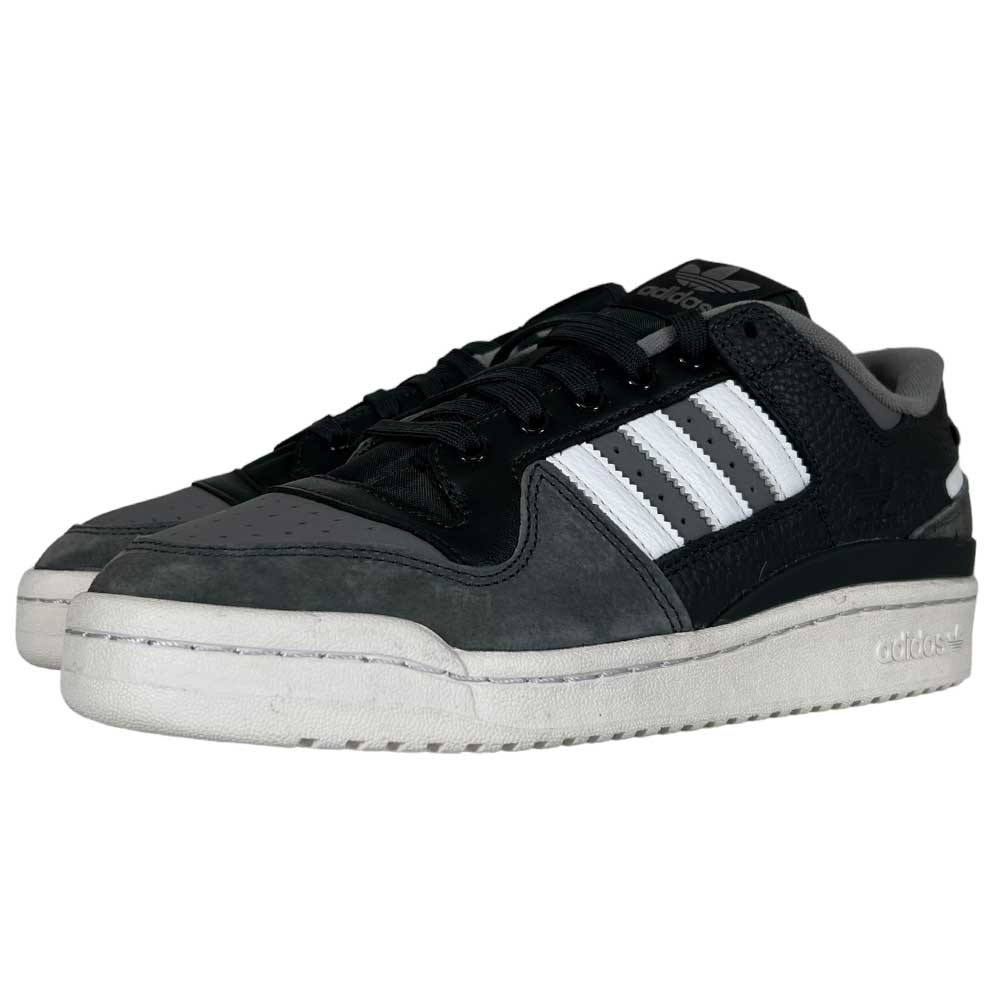 The Forum 84 Low Adidas Skateboarding Carbon White Gray Leather Shoes feature black and gray tones, white soles, and the iconic three white stripes on the side, displayed on a white background.