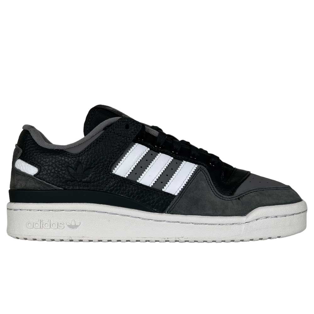 The Forum 84 Low Adidas Skateboarding Carbon White Gray Leather Shoes feature a black and gray design with white stripes, black laces, a white sole, and the Adidas logo embossed on the heel and midsole.