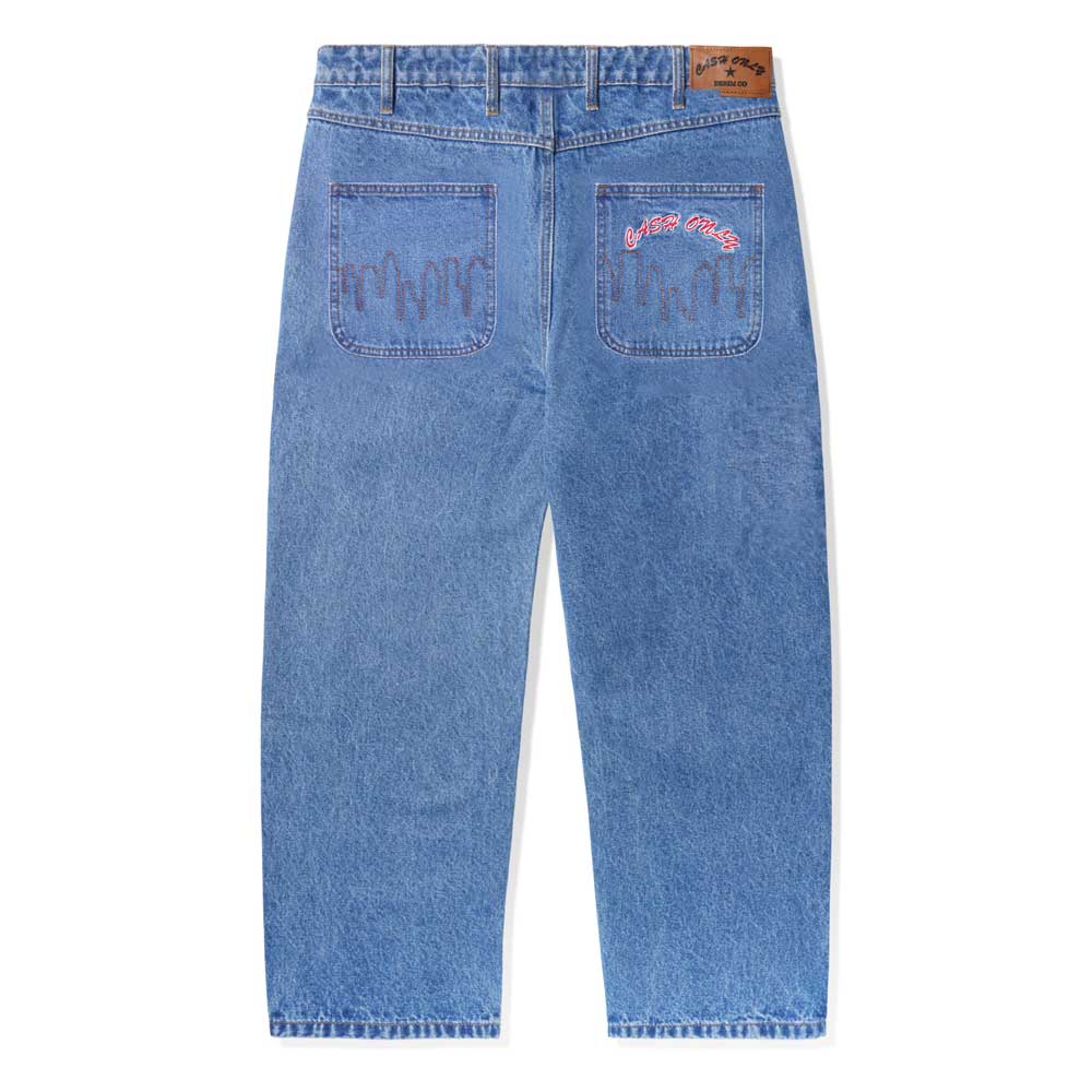 The Logo Baggy Denim Jeans Washed Indigo Cash Only are shown from the back, with two large pockets: the left has a wavy dark blue design, and the right features matching accents plus pink cursive "Cactus Mate" text.