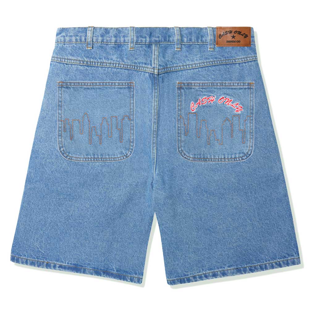 The Logo Baggy Denim Shorts Washed Indigo Cash Only are shown from the back with brown dripping stitch details on the pockets. "CASH ONLY" is embroidered in red and white on the right pocket and leather waistband patch.