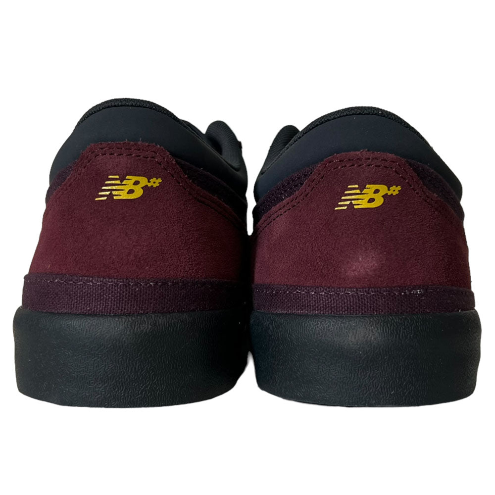 Back view of the New Balance Numeric 417 WBP Franky Villani Eggplant Black Suede Skateboarding Shoes, showcasing yellow NB heel logos, designed in collaboration with Franky Villani.
