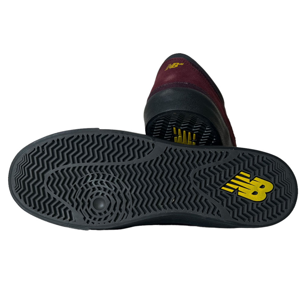 The 417 WBP New Balance Numeric Franky Villani Eggplant Black Suede Skateboarding Shoe is displayed sole-up, showing a black rubber tread with a yellow NB logo—designed for grip and inspired by pro skater Franky Villani.