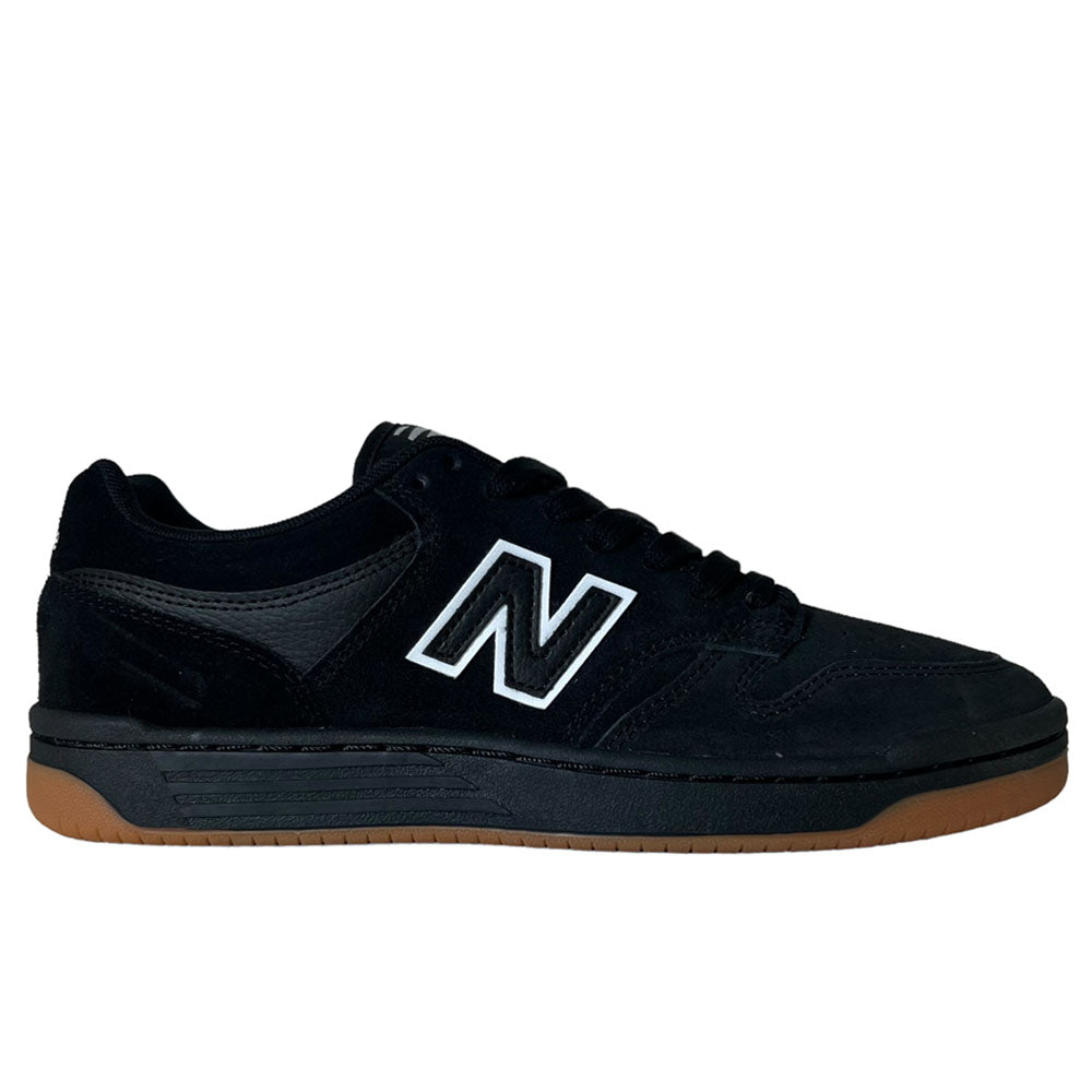 The 480 SBW New Balance Numeric Shoes in Suede Black White feature a black upper, a white outlined N logo on the side, black laces, and a brown rubber sole, shown in side profile against a white background.