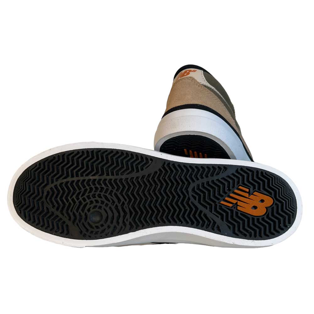 A pair of 417 FFU Franky Villani New Balance Numeric Suede Shoes in tan, olive, white, and black are shown, with one shoe displaying a black sole featuring an orange New Balance logo and a textured grip pattern.