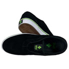 A pair of Swampy Slip On Opus Footwear black and green suede shoes features white soles and green logo accents—one shoe shown from the top, the other on its side displaying the wavy sole pattern.