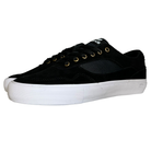 The Standard Low Opus Footwear Black White Suede Shoes feature a black and white suede design, white rubber soles, gold eyelets, black laces, a textured side pattern, and a logo tag on the tongue.