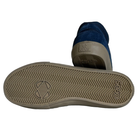 A pair of Standard Mid Opus Footwear Navy Cream Suede Shoes, one upright and the other on its side to show the beige rubber sole’s herringbone tread and OPUS embossing.