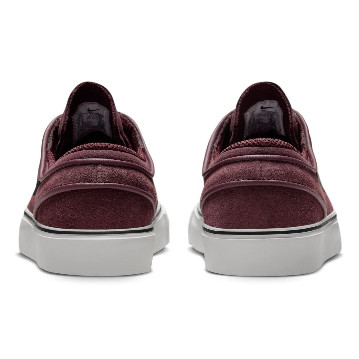 A pair of Janoski GS YOUTH Burgundy Crush Black Suede Nike SB Skateboarding Shoes, viewed from the back, with white soles and black Nike Swoosh logos on the sides.