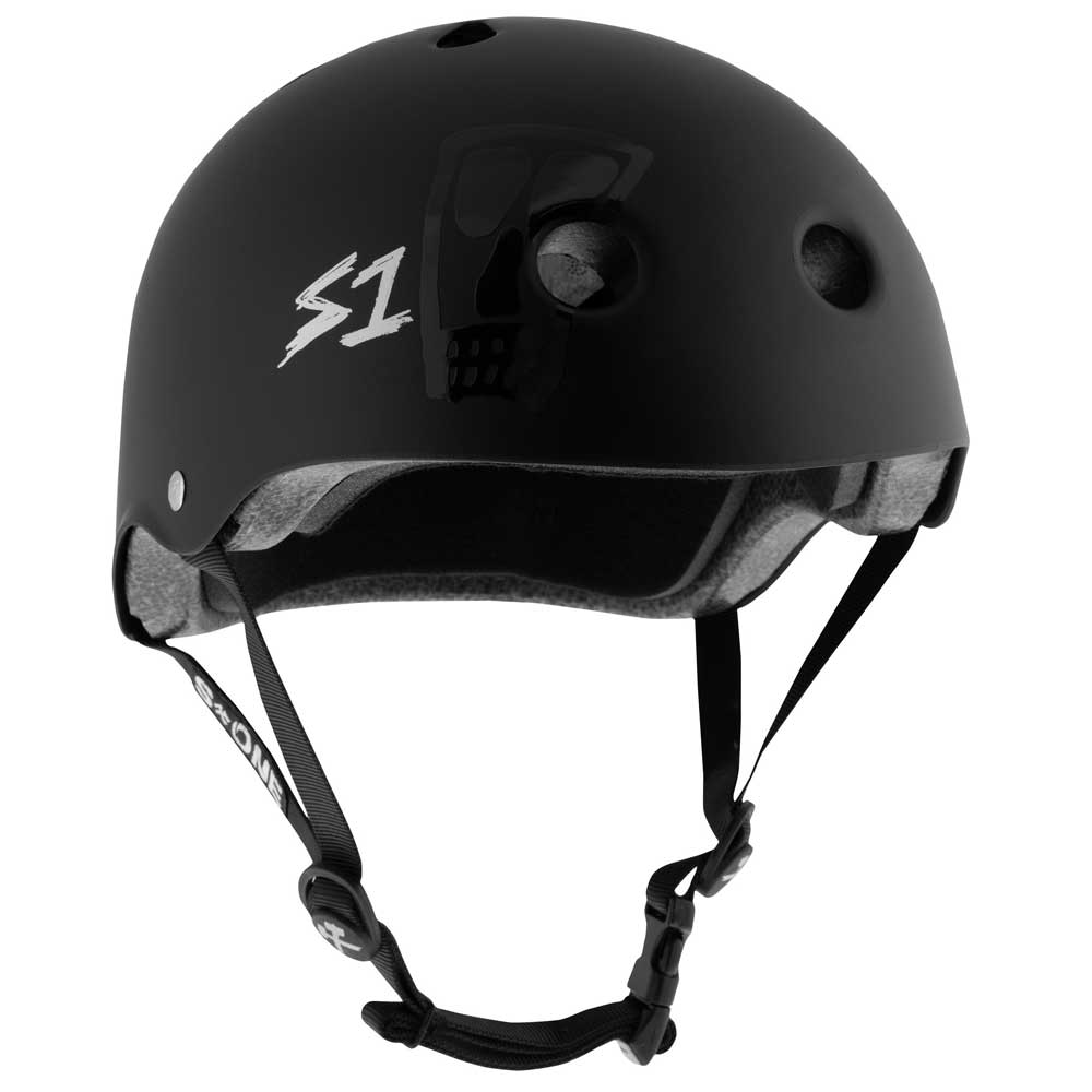 The Lance Mountain Vato Skull Black Matte Lifer S1 Helmet features ventilation holes, a white “S1” logo, a subtle skull graphic, and an adjustable chin strap for a secure fit.