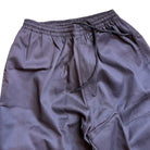 A close-up of Texas Icon Brown Southside 94 Pants, showcasing a loose skate fit with elastic waistband and drawstring, displayed on a white background—ideal for vert ramp skateboarding.