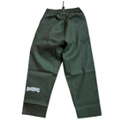 The Texas Icon Dark Green Southside 94 Pants are dark green drawstring skate pants with a wide leg fit and a white graphic text logo on the lower left leg, displayed flat on a white background.