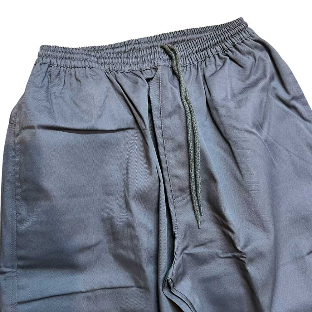 A close-up of Texas Icon Gray Southside 94 Pants featuring an elastic waistband and drawstring, highlighting natural fabric folds—ideal loose-fitting rugged pants for daily comfort.