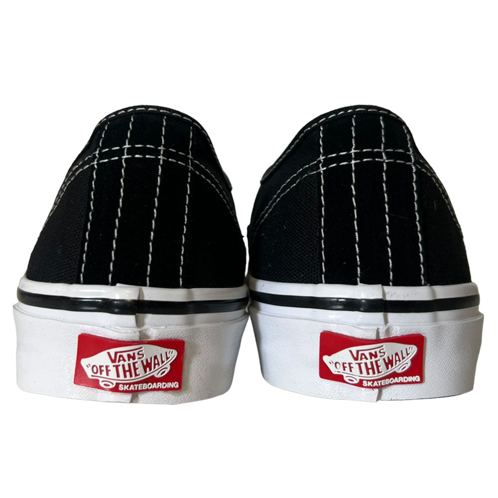 The VNOA5FC8Y28 Suede Canvas Black White Authentic Vans Skateboarding Shoes are shown from the back, featuring white stitching and red Vans Off The Wall logos on the white soles.