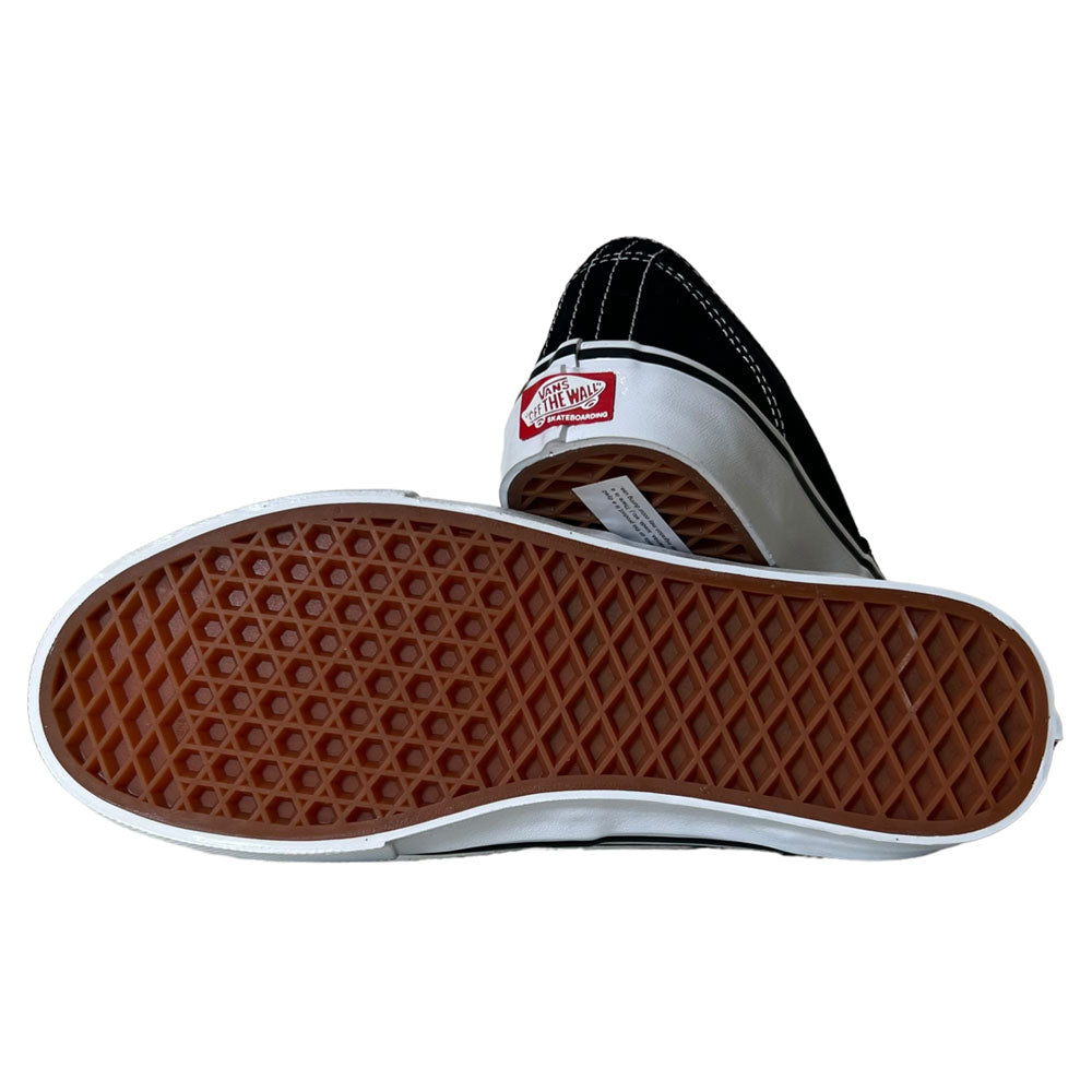A pair of VNOA5FC8Y28 Suede Canvas Black White Authentic Vans Skateboarding Shoes—one upright showing the heel logo, the other flipped to reveal the signature brown waffle sole for standout style and performance.