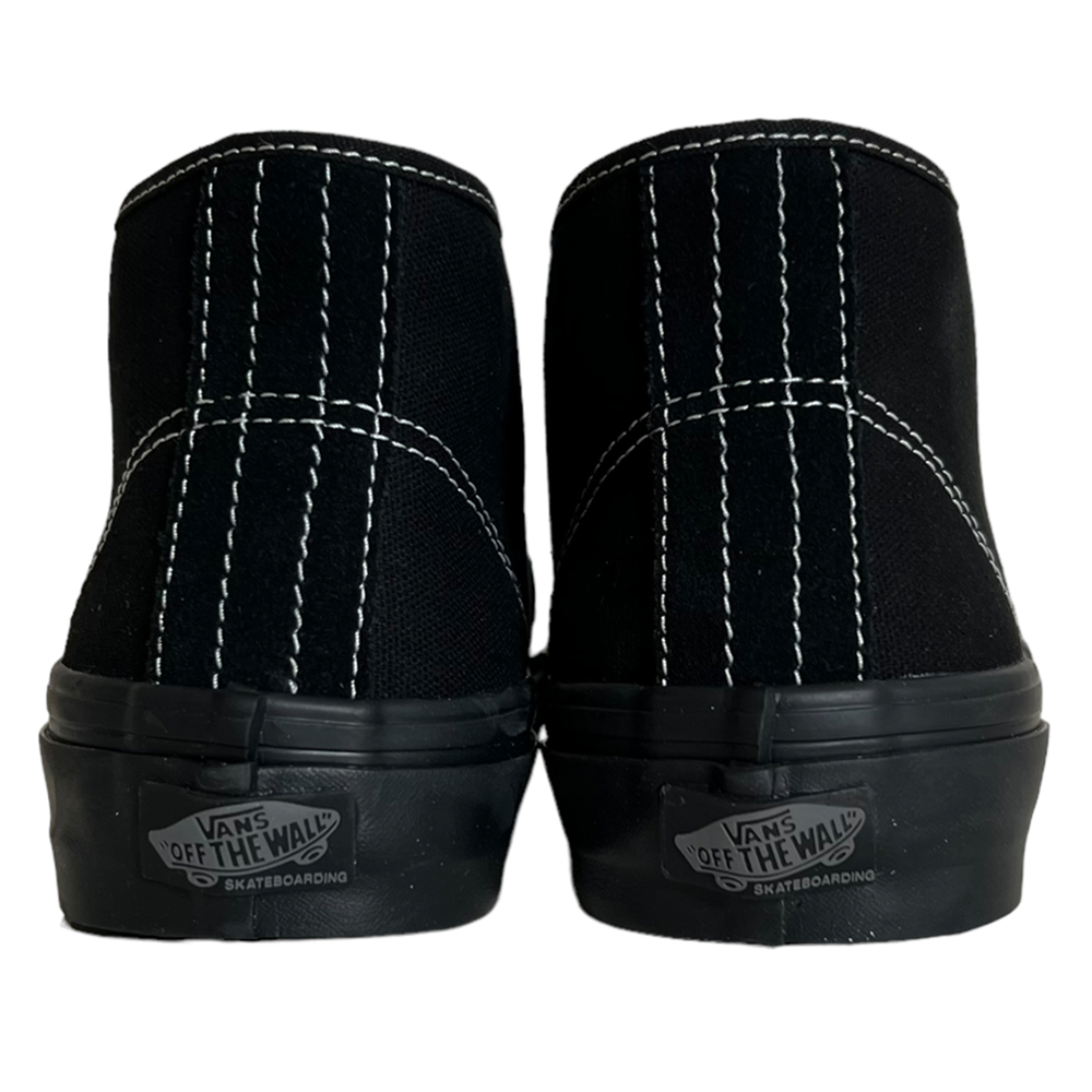 The VN0A27371OJ Suede Black Authentic Mid Vans Skate Shoes are shown from the back with white stitching and "Vans Off The Wall" heel logos. These durable skate shoes feature PopCush cushioning for extra comfort.