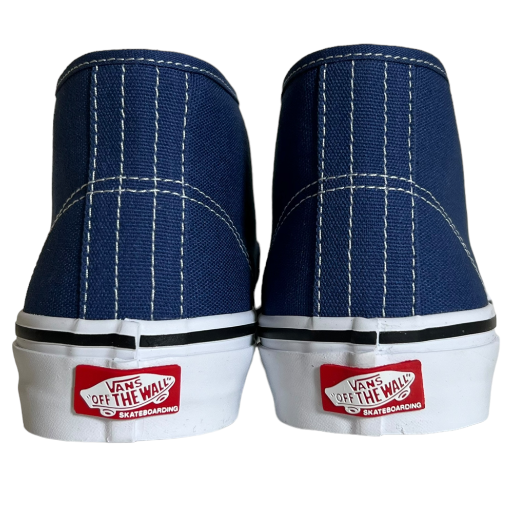 Back view of VN0007PHO2Y Steve Navy Authentic Mid Vans Skate Canvas Shoes featuring white stitching, white soles, red Vans Off the Wall Skateboarding heel logos, and enhanced PopCush cushioning for comfort.