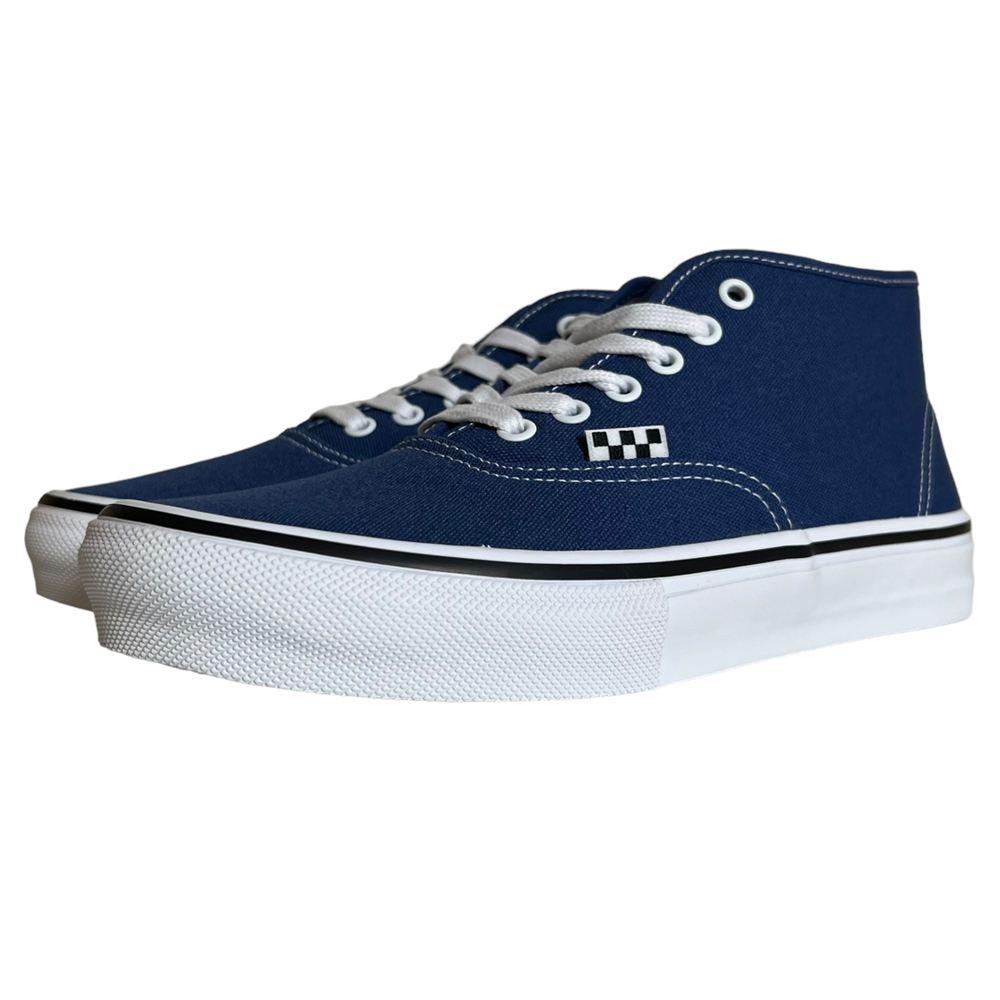 A pair of VN0007PHO2Y Steve Navy Authentic Mid Vans Skate canvas shoes with white laces, eyelets, and rubber soles. Features the iconic checkerboard logo, PopCush cushioning, and a black line along the sole edge.