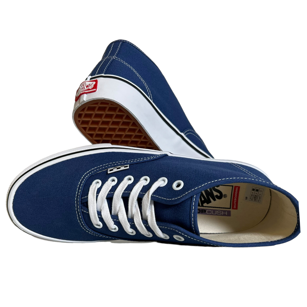 The VN0007PHO2Y Steve Navy Authentic Mid Vans Skate Canvas Shoes feature navy canvas uppers, white laces and stitching, a gum waffle sole, red Vans heel logo, and PopCush cushioning for enhanced skate comfort.