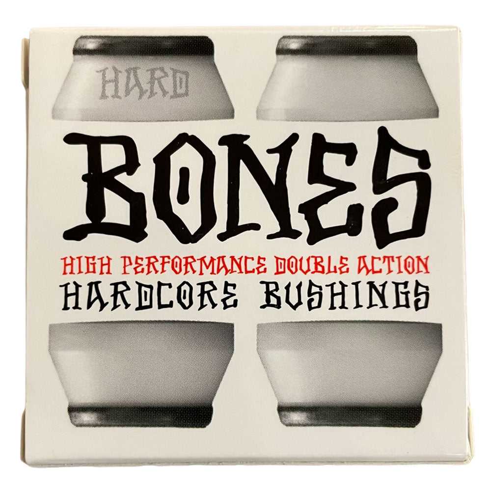 A box of Bones Hardcore Bushing Hard White features bold black and red text and displays four white hard skateboard bushings—one marked with "HARD.