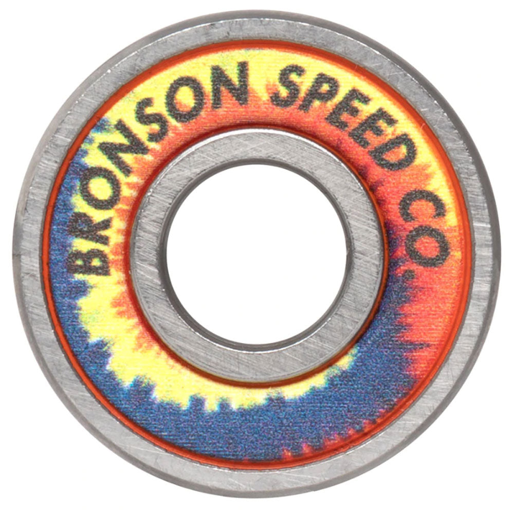 A close-up of the Bronson Speed Co. Bearings Aaron Jaws Homoki Pro G3 shows a skateboard bearing with a vibrant tie-dye pattern and "BRONSON SPEED CO." text on the outer ring, inspired by pro skater Aaron Jaws Homoki.