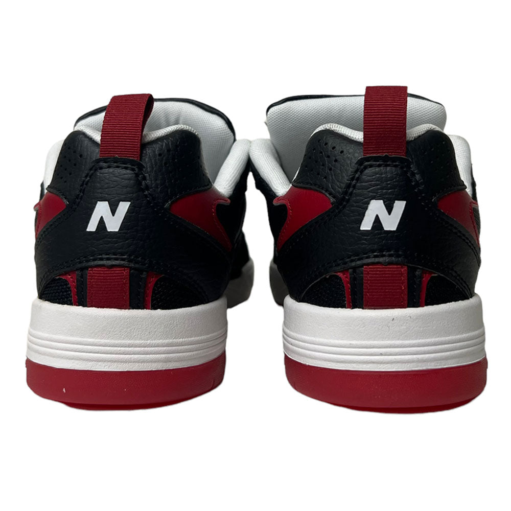 A pair of New Balance NM 808 Tiago Black Red White sneakers viewed from the back, featuring a white N logo on each heel and showcasing Tiago's signature style.