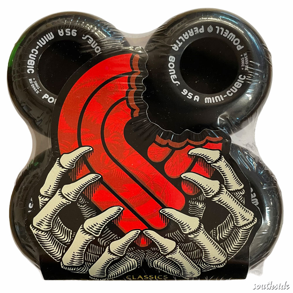 Four black Powell Peralta Mini Cubic skateboard wheels, 64mm 95A, with red graphics of a stylized snake and skeletal hands. Packaged together and labeled USA.