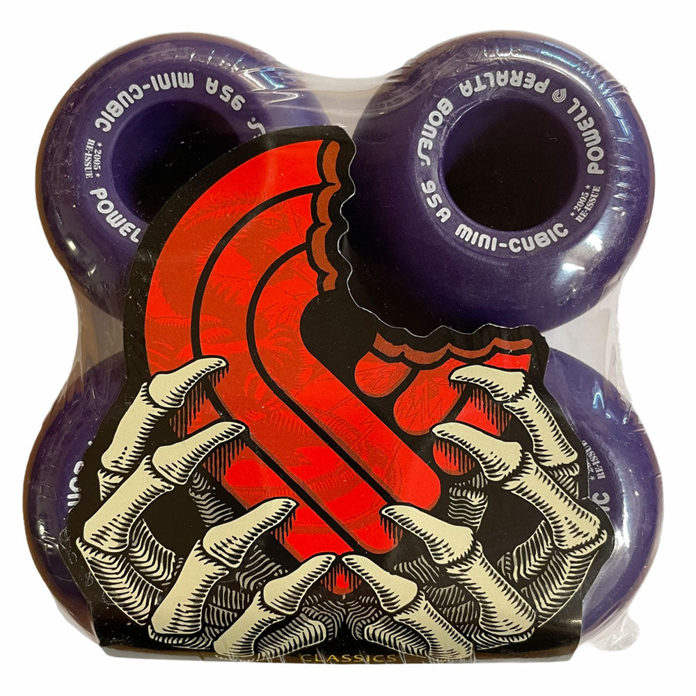 Four Powell Peralta Mini Cubic 64mm 95A purple skateboard wheels, packaged with a red snake entwined through skeletal hands illustration on the front.