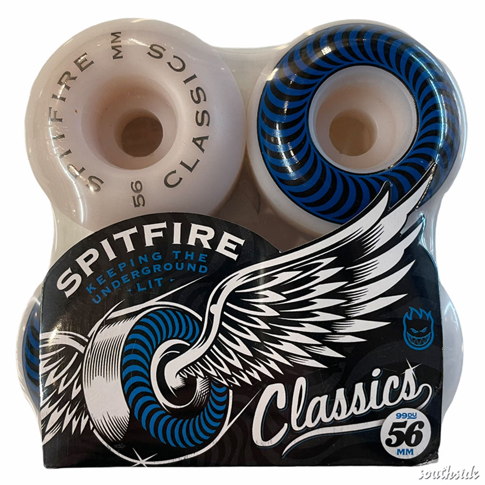 A four-pack of Spitfire Wheels Classic 56mm99A skateboard wheels in white, featuring blue and black spiral graphics and winged logo packaging labeled "Classics" and "Keeping the Underground Lit.