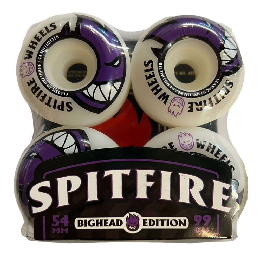 Four Spitfire Wheels Bighead 54mm99A, white with purple and black illustrated face graphics, packaged together. The label features bold SPITFIRE 54MM BIGHEAD EDITION 99 text—classic 54mm99A style for your setup.