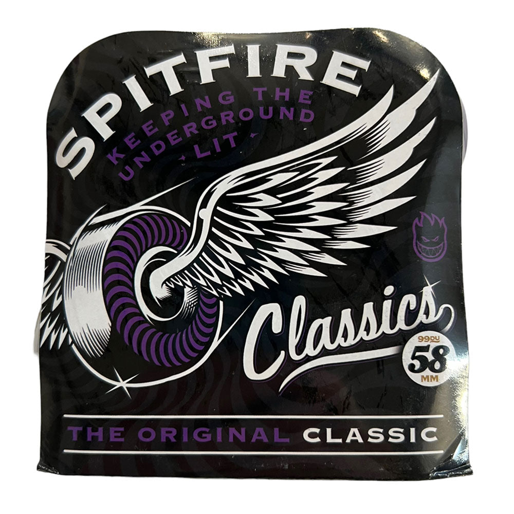A black package of Spitfire Wheels Classics 58mm99A shows a white winged wheel, purple accents, and reads: Spitfire Classics, Bighead logo, Keeping the Underground Lit, The Original Classic 58mm 99A.