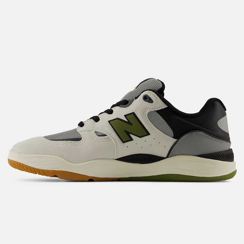 The 1010 B Tiago Lemos Sea Slate Dark Olivine New Balance Numeric Suede Skateboarding Shoe features a white, gray, black, and green colorway with mesh panels, a gum sole, and a bold “N” logo on the side. Viewed from the left, this pro-endorsed model is inspired by skateboarding legend Tiago Lemos.