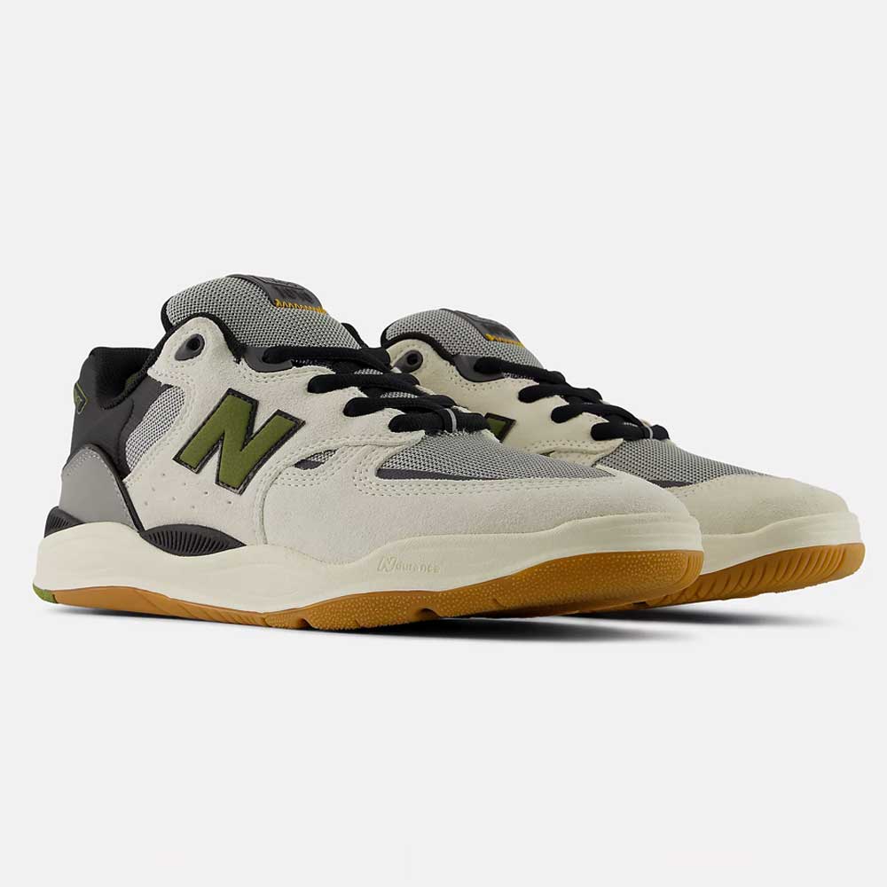 A pair of New Balance Numeric 1010 B Tiago Lemos Sea Slate Dark Olivine Suede Skateboarding Shoes—featuring cream, gray, and black panels, olive green "N" logos, black laces, and gum rubber soles—are positioned side by side on a plain white background.