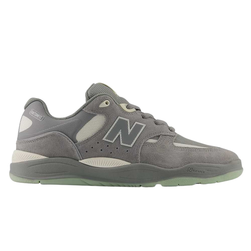 A Slate Grey and Sea Salt New Balance Numeric 1010 PS Tiago Lemos skateboarding shoe, crafted with suede and mesh panels, featuring a large “N” on the side, grey laces, a translucent rubber sole, and a durable ABZORB midsole for enhanced comfort and support.