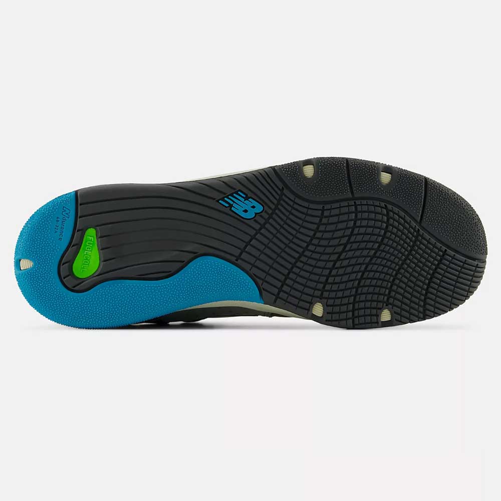 The image shows the sole of the 1010 Y Tiago Lemos Gray Day Marble Head Island Blue New Balance Numeric Suede Skateboarding Shoe, with black and blue rubber, textured grip patterns, a green segment, and a blue New Balance logo at the center.