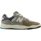 Introducing the 1010 Y Tiago Lemos Gray Day Marble Head Island Blue New Balance Numeric Suede Skateboarding Shoes—a New Balance skate sneaker from the Tiago Lemos line, designed with a mesh and suede upper in shades of gray, brown, and cream. Featuring a white “N” logo on the side, white laces, and a two-tone rubber sole detailed with blue and black accents.
