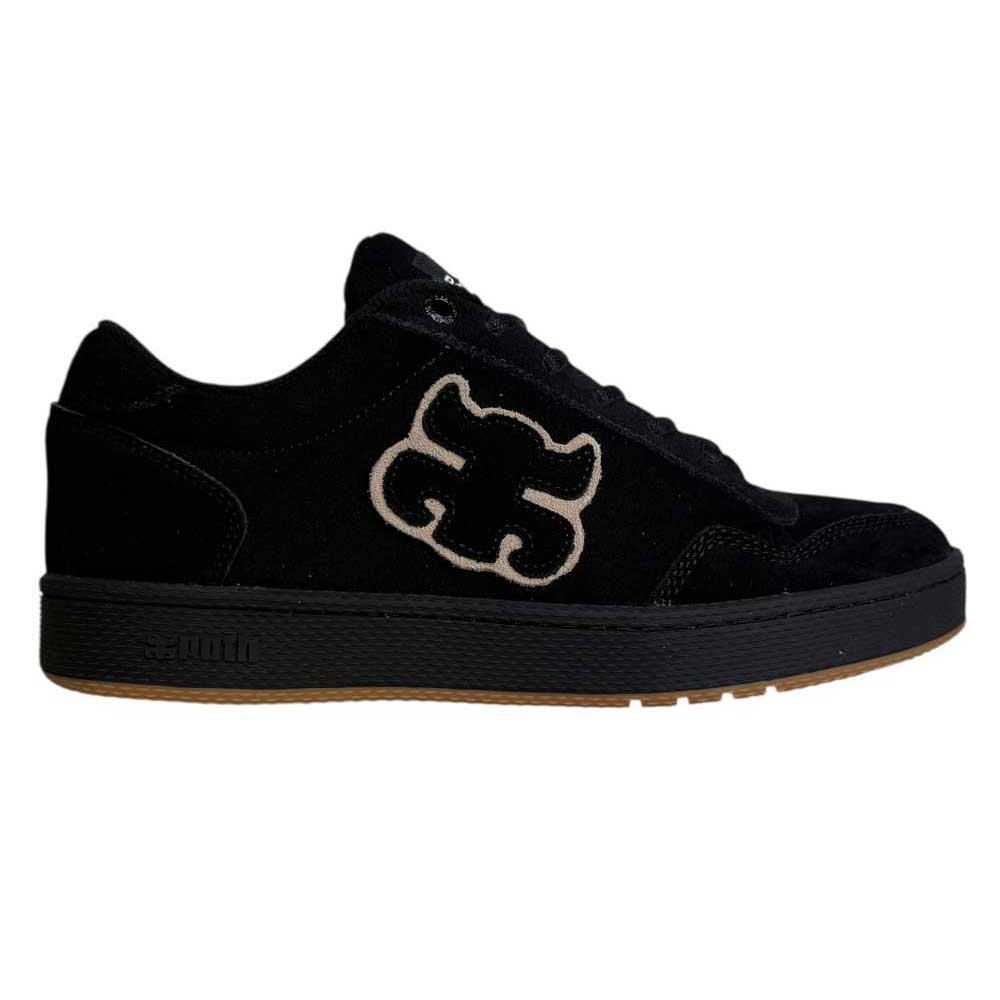 1985 Black Tan I Path Shoes Skateboarding: These black suede low-top skateboarding shoes feature a beige logo patch on the side, black laces, and a black sole with a gum rubber bottom. Perfect for anyone seeking durable and stylish suede skate shoes.