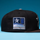 The Magician Houston Astros New Era Hat 5950 Fitted is a black baseball cap featuring a star patch with “2000” and “Inaugural Season” on the side, honoring the Houston Astros, displayed against a blue background.