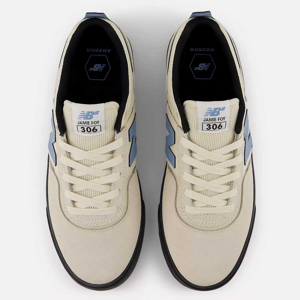 Top view of the 306 SBB Jamie Foy Sea Salt Still Water New Balance Numeric suede skateboarding shoes, featuring off-white uppers with light blue accents, displayed on a plain white background.